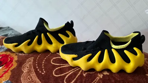 Black and Yellow Slip-On Knit Sneakers with Wavy Sole - Used in a good condition. Size - 34, fit 33