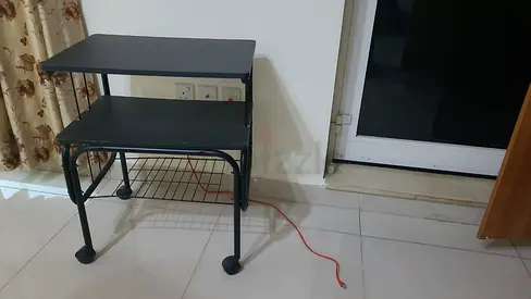 Compact black computer desk with keyboard shelf and wheels
