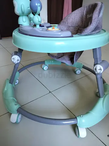 Baby walker with toys and adjustable seat - good condition never used