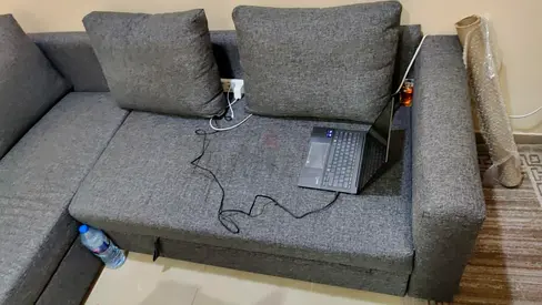 L-shaped grey fabric corner sofa — good condition with pull up for a double size bed