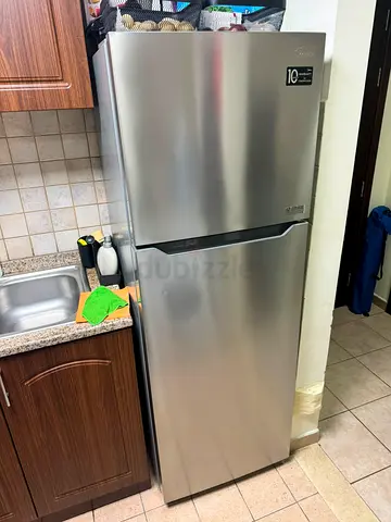 Silver top-freezer refrigerator - good condition, 10-year compressor warranty