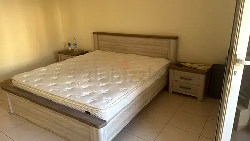 king  bed frame with mattress and two bedside tables - light wood