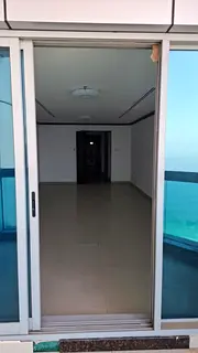 Annual apartment for rent on Ajman Corniche: two bedrooms, a living room, and a maid’s room, with 