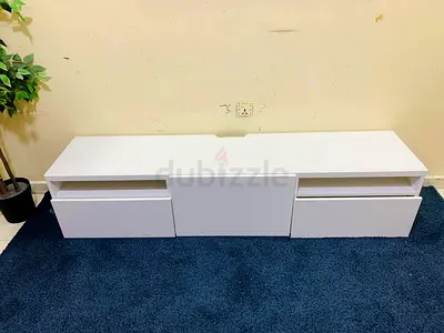 Low white TV unit with drawers and open shelves - good condition