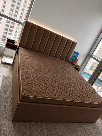 New bedQueen upholstered storage bed with headboard - good condition