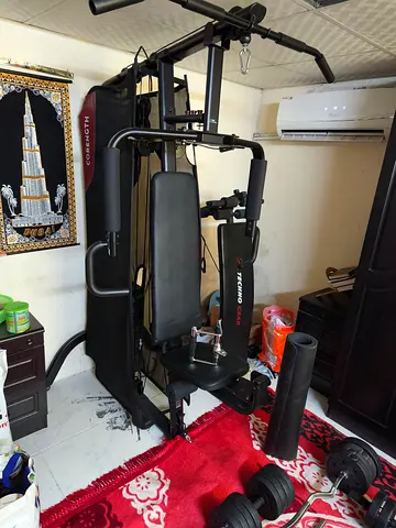 Home gym set with multi-station, bench press and adjustable dumbbells — well maintained