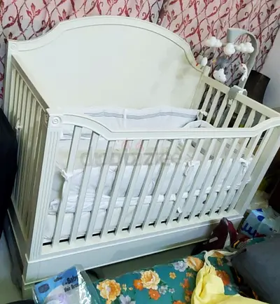 IKEA white wooden baby crib with mattress