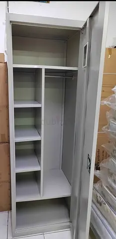 Light grey single-door metal wardrobe with shelves and hanging rail