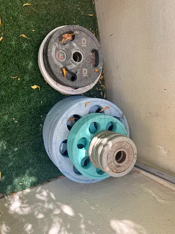 Used weight plates set — various sizes for home gym