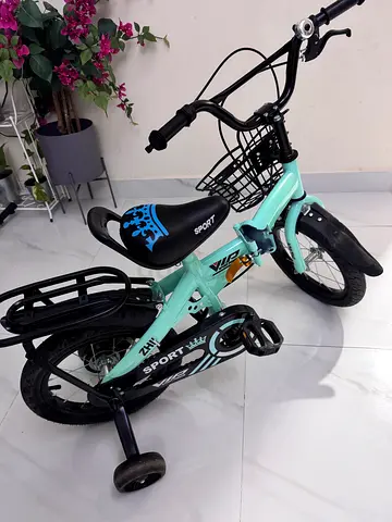 Childrens mint green foldable bicycle with training wheels and basket