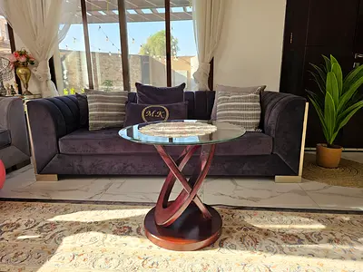Modern glass-top round coffee table with wooden twisted base