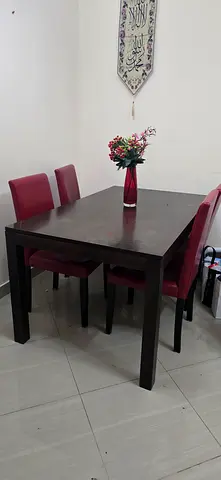 0508148117 Wooden dining table with 4 red upholstered chairs - good condition