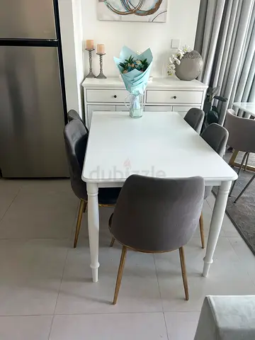 White dining table with 5 grey upholstered chairs - good condition