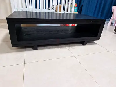 Solid black low TV/entertainment console table with open shelf