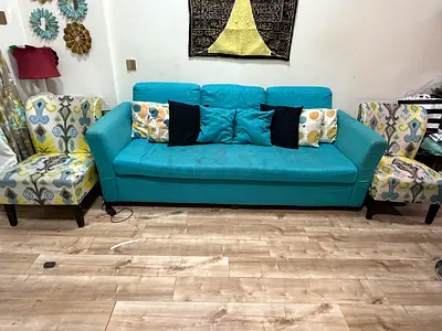 Turquoise 3-seater sofa with two patterned accent chairs