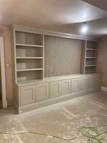 Custom built-in wall unit with shelving and cabinets