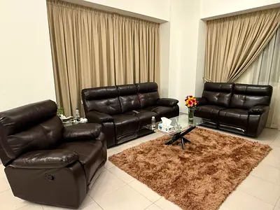 Dark brown leather 3-piece reclining sofa set with glass coffee table and rug