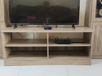 Large wooden entertainment center with display cabinets. Excluding the TV and team inside the shell.