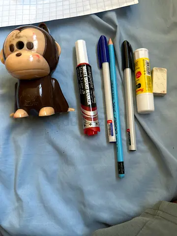 Mixed stationery: pens, pencil, whiteboard marker and eraser