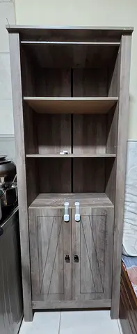 Tall wooden storage cabinet with shelves and lockable lower cupboard