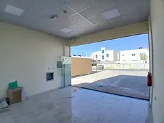 For annual rent in the Emirate of Ajman - four adjacent commercial shops in a very new building (fir