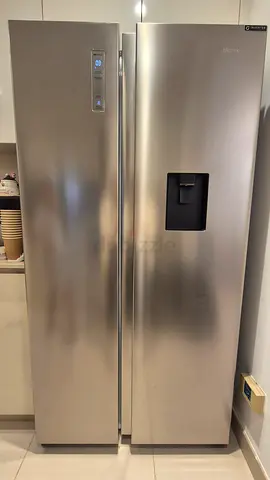 Large stainless steel side-by-side refrigerator- good condition.