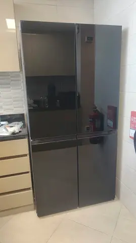 Large black mirrored 4-door refrigerator in excellent condition