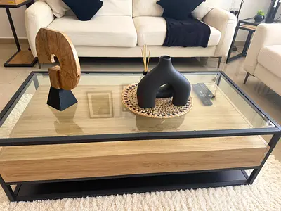 Modern glass-top coffee table with wood drawer and black metal frame