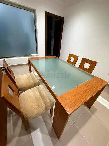 Wooden dining table with glass top + 4 matching chairs — good condition
