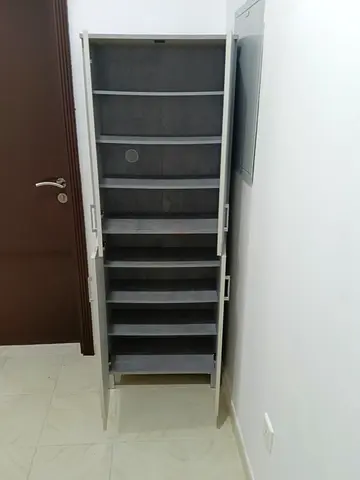 Slim tall shoe cabinet with multiple shelves — good condition