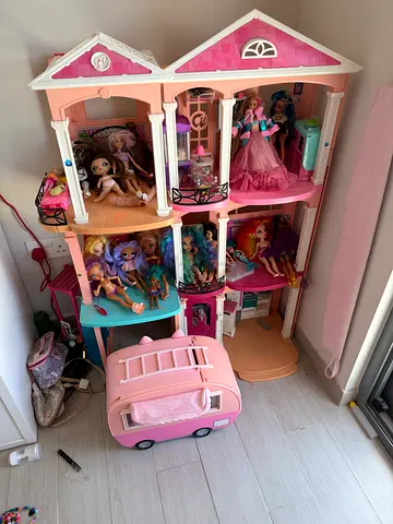 Large Pink Dollhouse with Multiple Dolls and Accessories