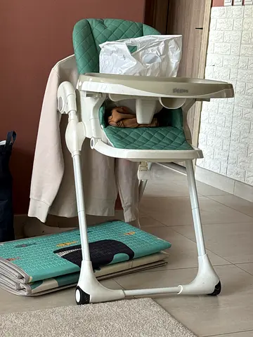 Used adjustable baby high chair - green quilted seat.Giggles brand