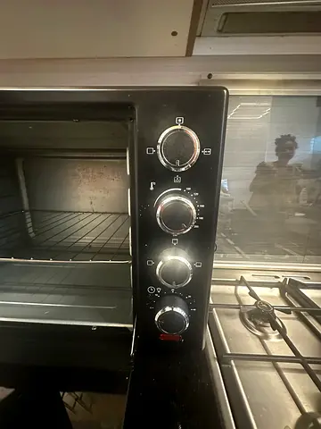 Used countertop electric oven with rotisserie and baking tray