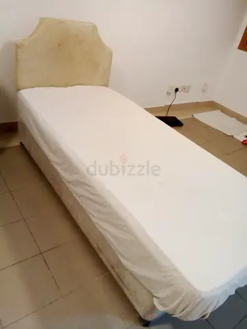 Single wooden bed frame with medical mattress