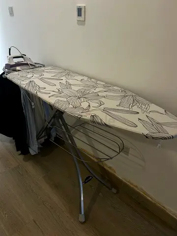 Ironing board with cover and built-in iron rest — good condition