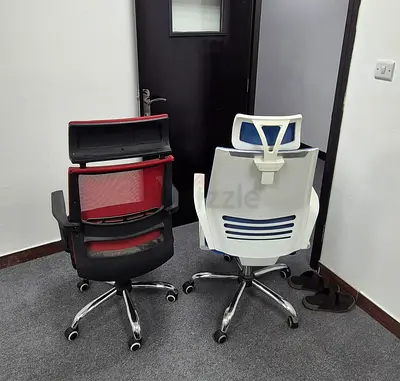 Two ergonomic office chairs — red mesh and blue fabric, good condition
