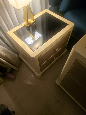 Pair of modern white bedside tables with Cream-colored bedroom dresser with attached mirror and six