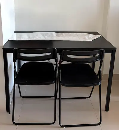 Small black dining table with 2 folding chairs - good condition