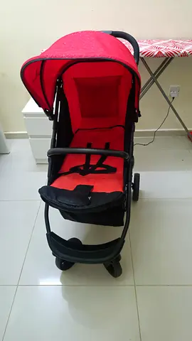 Red baby stroller in good condition