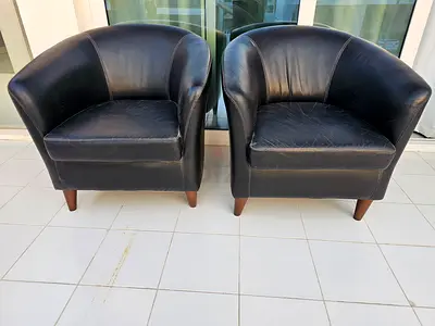 Pair of black leather tub chairs - good used condition