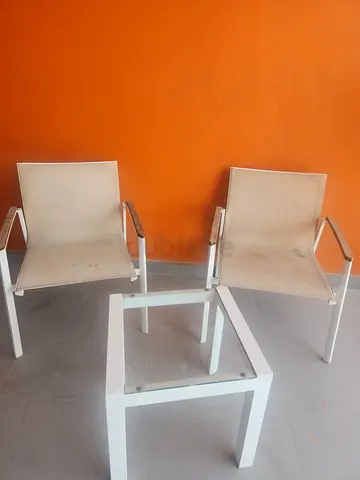 Pair of white metal outdoor/indoor chairs with glass-top side table