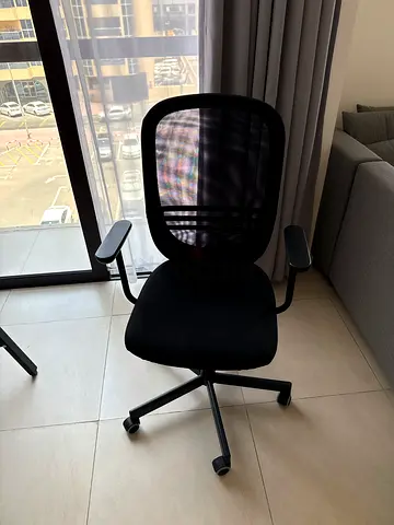 Black ergonomic mesh office chair with armrests