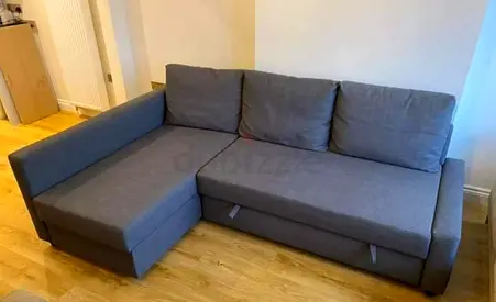 Used grey L-shaped sectional sofa with storage - good condition