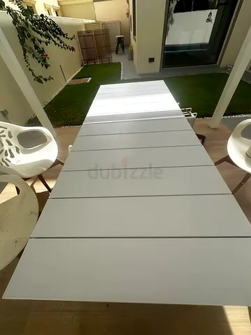 Long white slatted outdoor dining table