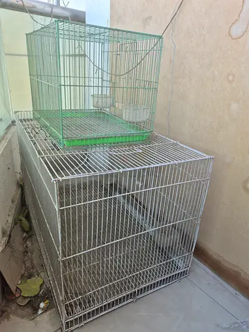 Two metal bird cages - small and large, used