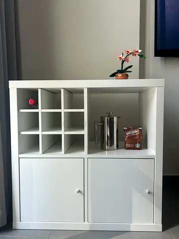 IKEA KALLAX 2x2 Shelving Unit with Doors and bottle insert.