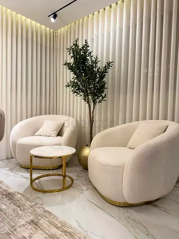 Pair of Modern Cream Curved Lounge Chairs with Gold Base