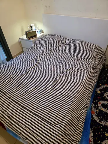 Queen-size bed from Ikea with bedside table