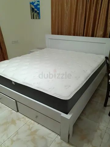 White wooden bed frame with storage drawers + mattress