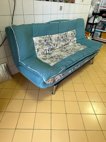 Blue fabric sofa bed / futon in good used condition